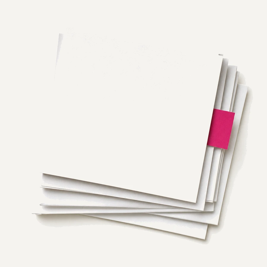 A fanned stack of blank index cards and folded sheets with a magenta marker slip.