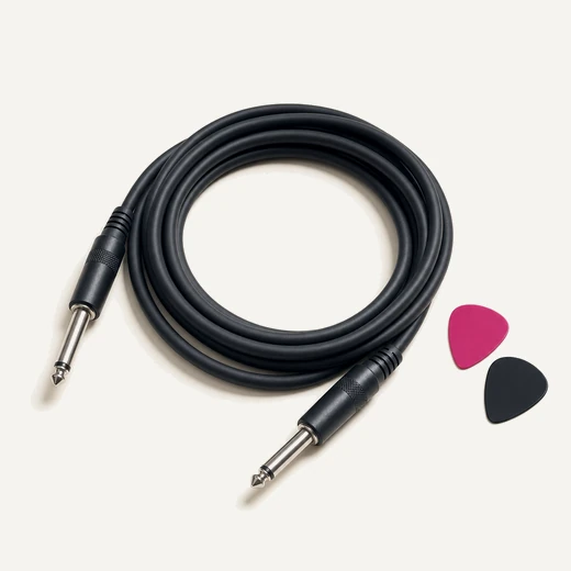 A loose coil of black instrument cable with two guitar plectrums beside it, one magenta.