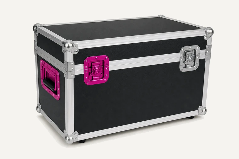 An unmarked black touring flight case with a magenta latch.